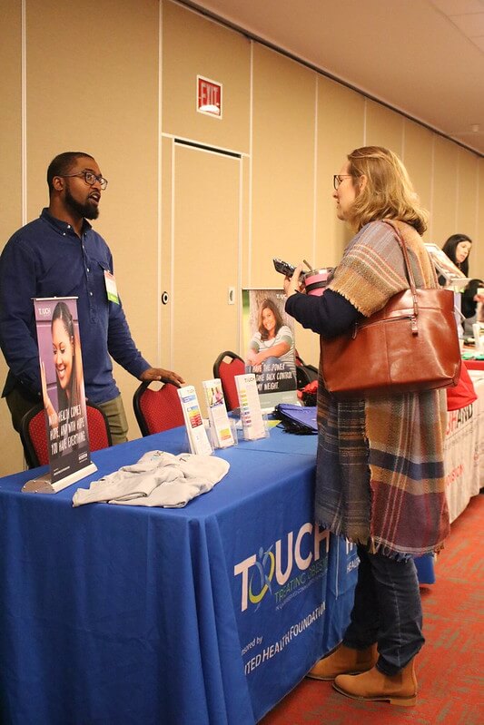 Imarogbe Stokes, HEALTH Research Institute Community Liaison, representing the Treating Obesity in Underserved Communities in Houston (TOUCH) program vendor booth.